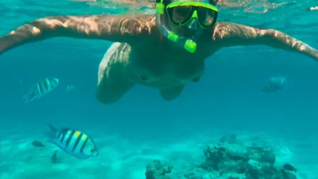 Dirty Lady flaunts her huge tits and underwater skills on a public beach