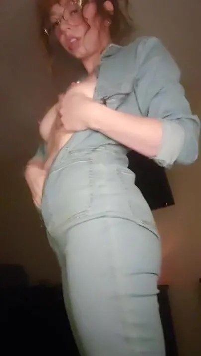Redhead over jeans tease